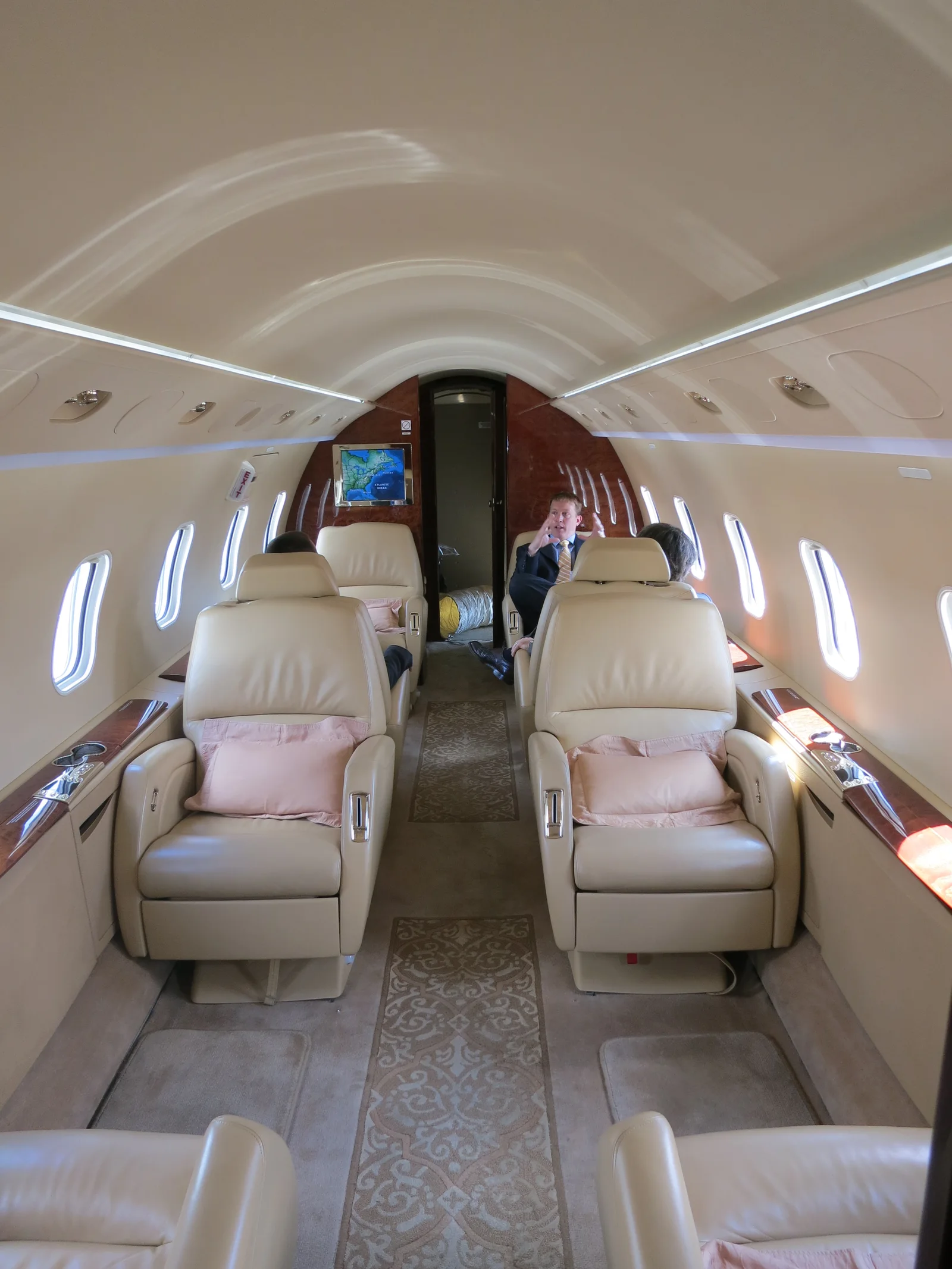 Cream leather seating and cabin of a private jet interior