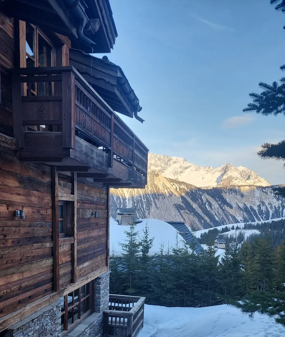 Snow-covered alpine chalet under a clear blue sky