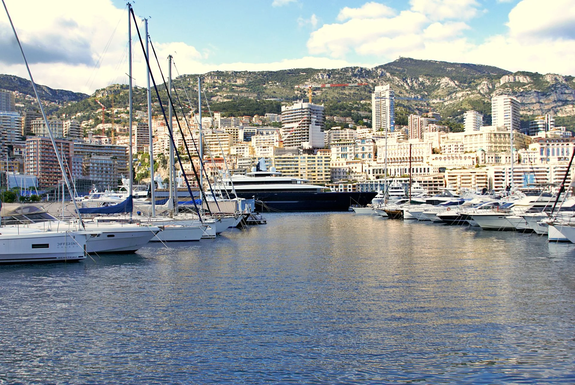 Harbour on the Riviera coast with yachts moored below hills
