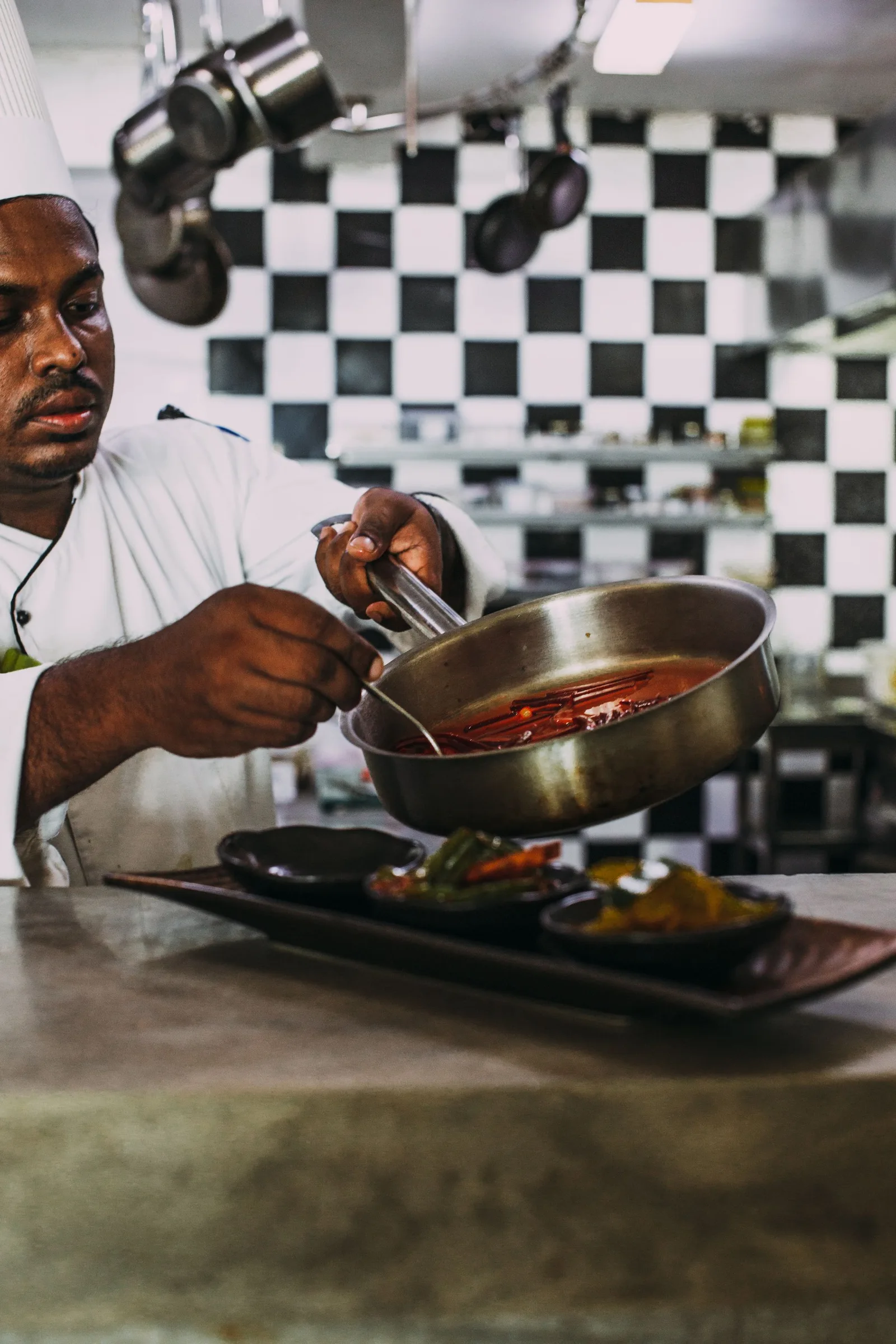 Hands preparing food in a professional kitchen